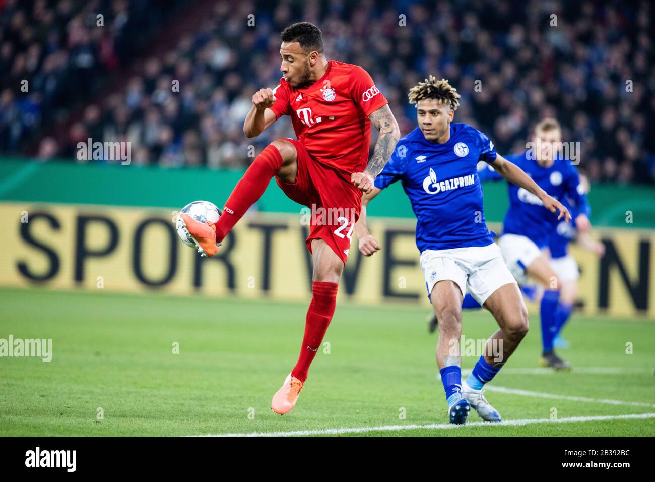 Gelsenkirchen, Germany, Veltins-Arena, 3.03.2020: Tolisso Corentin of Muenchen (L) assist the bal, against Jean-Clair Todibo of Schalke 04 during the Stock Photo