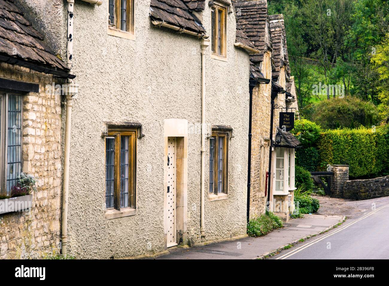 Stone houses wobble and lean down the road in Castle Combe, a small