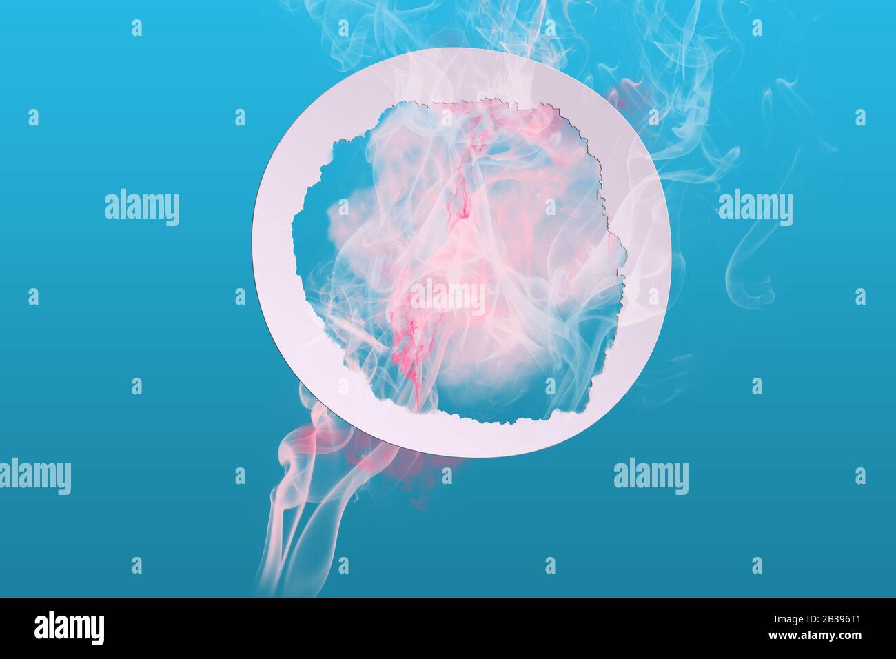 Abstract soft pink color paint smoke explosion with round frame on blue background. Creative minimal design composition with copy space Stock Photo