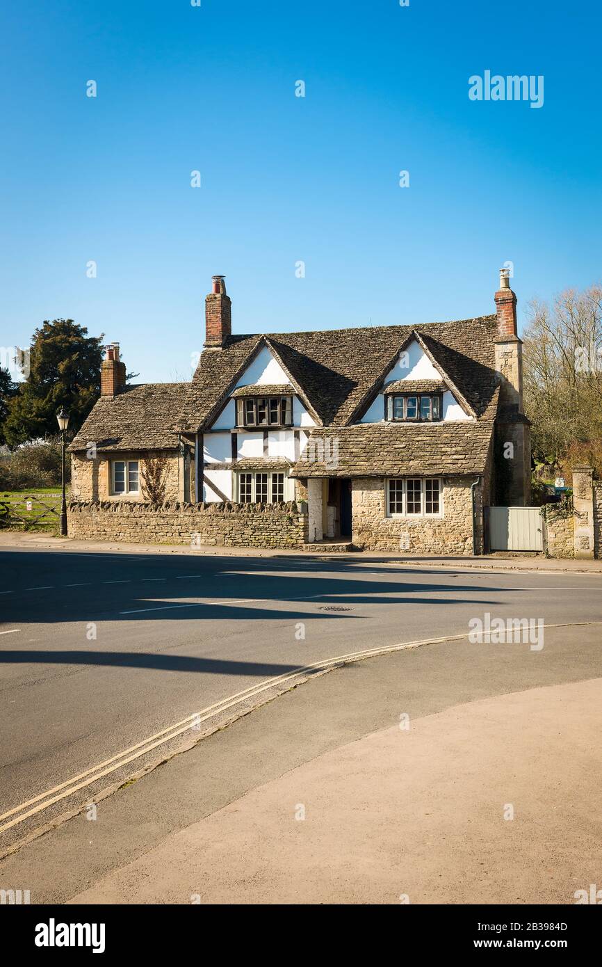 A fine old detached stone cottage in Lacock Wiltshire England UK, a village popular with film-makers worldwide Stock Photo