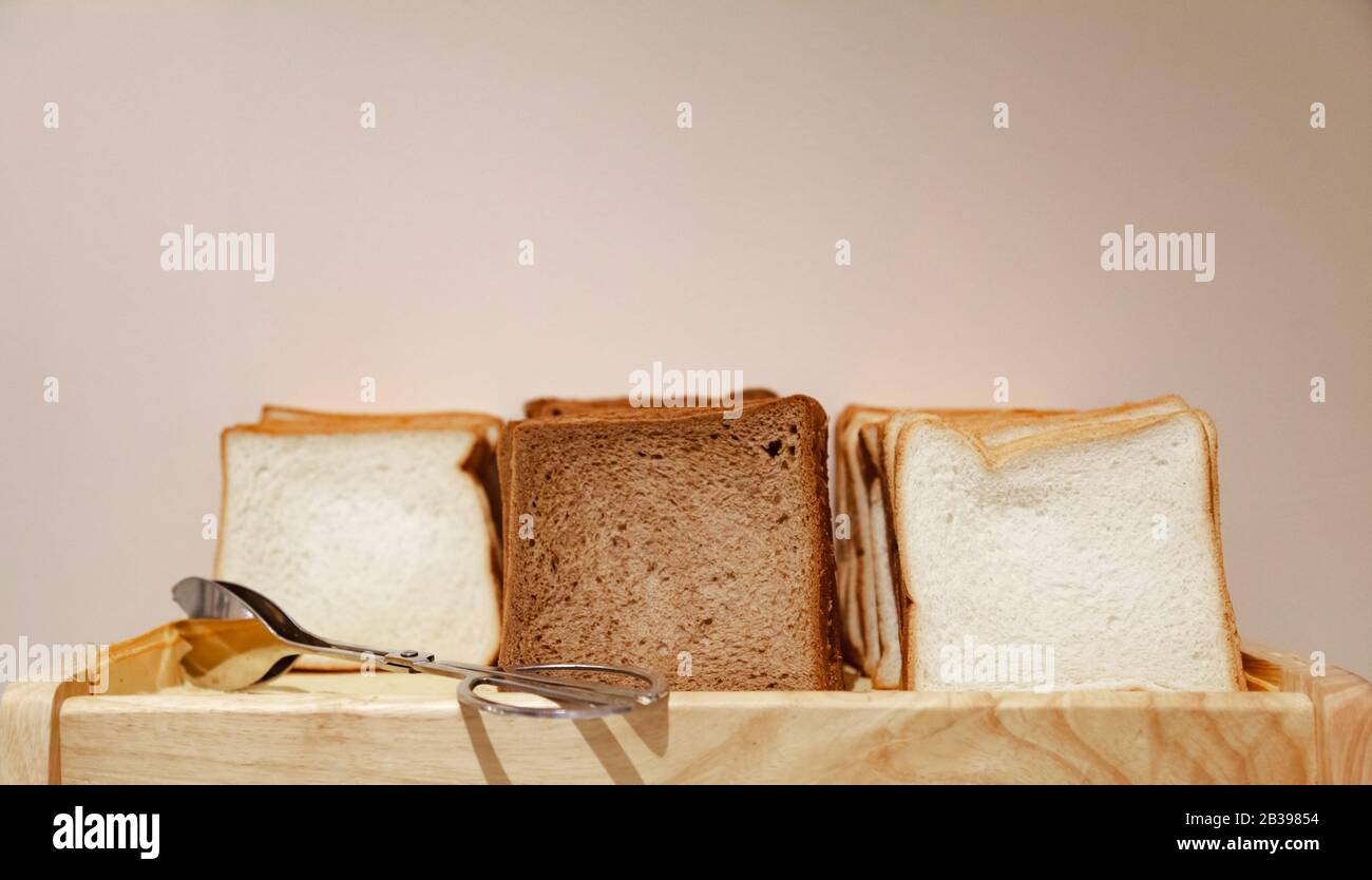 Selective Focused White and Brown Healthy Organic Farmhouse Sandwich Bread Lines, ready to eat or toast in morning breakfast meal pantry. Hotel Food B Stock Photo