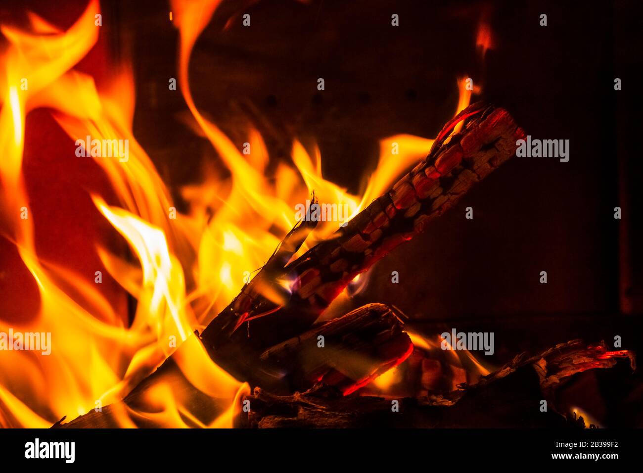 Glowing Hot Charcoal Briquettes Close-up Background Texture Stock Photo