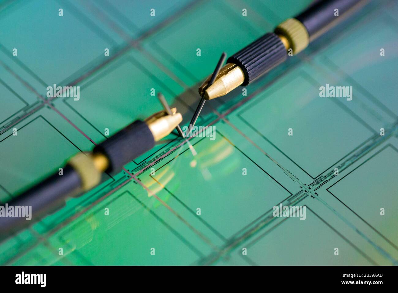 Manual probe system with needles for test of semiconductor on silicon wafer. Selective focus