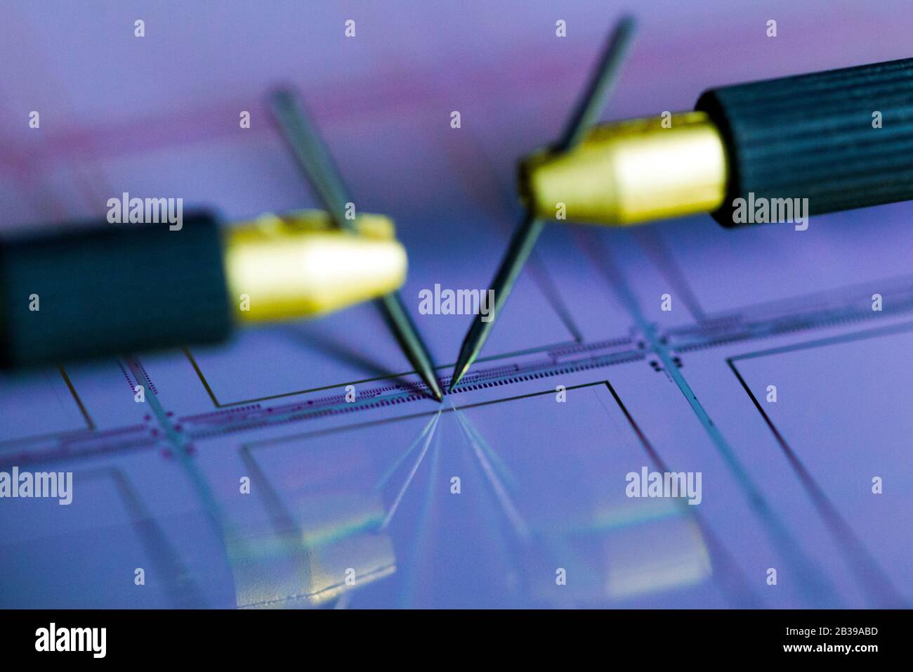 Manual probe system with needles for test of semiconductor on silicon wafer. Selective focus