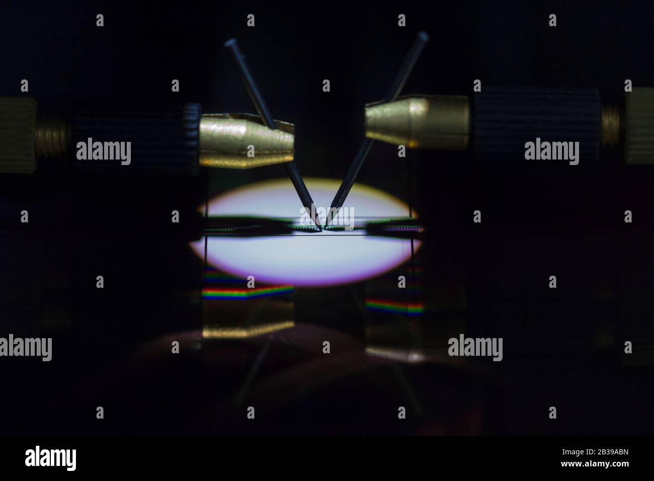 Manual probe system with needles for test of semiconductor on silicon wafer. Selective focus