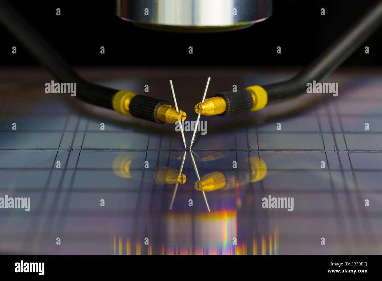 Close up of examining a sample of microchip transistor with probe station under the microscope in laboratory.A semiconductor on a silicon wafer Stock Photo