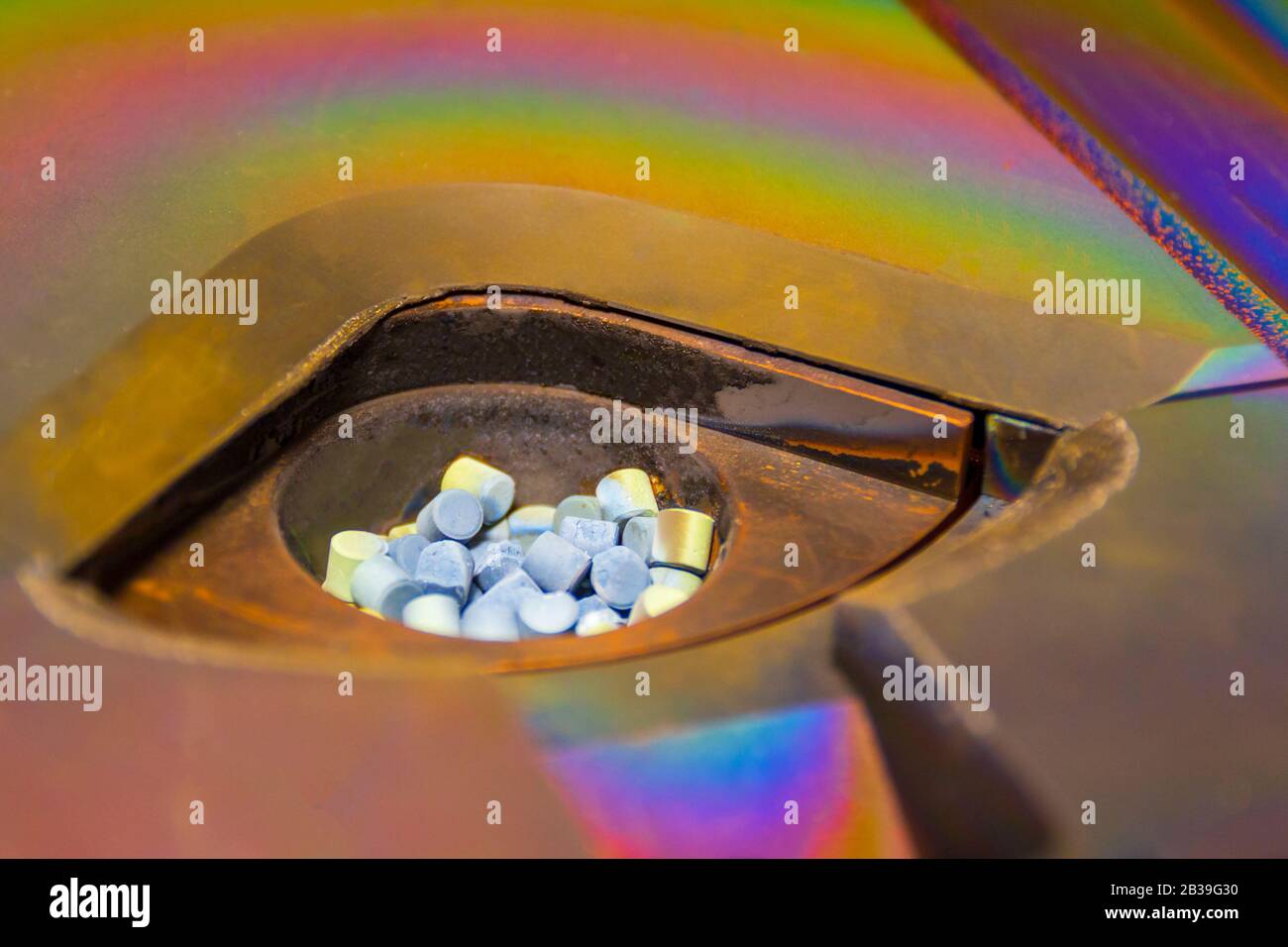 Grey color granules in a crucible for deposition films , vacuum vapor deposition chamber process, copy space, selected focus, narrow depth of field Stock Photo