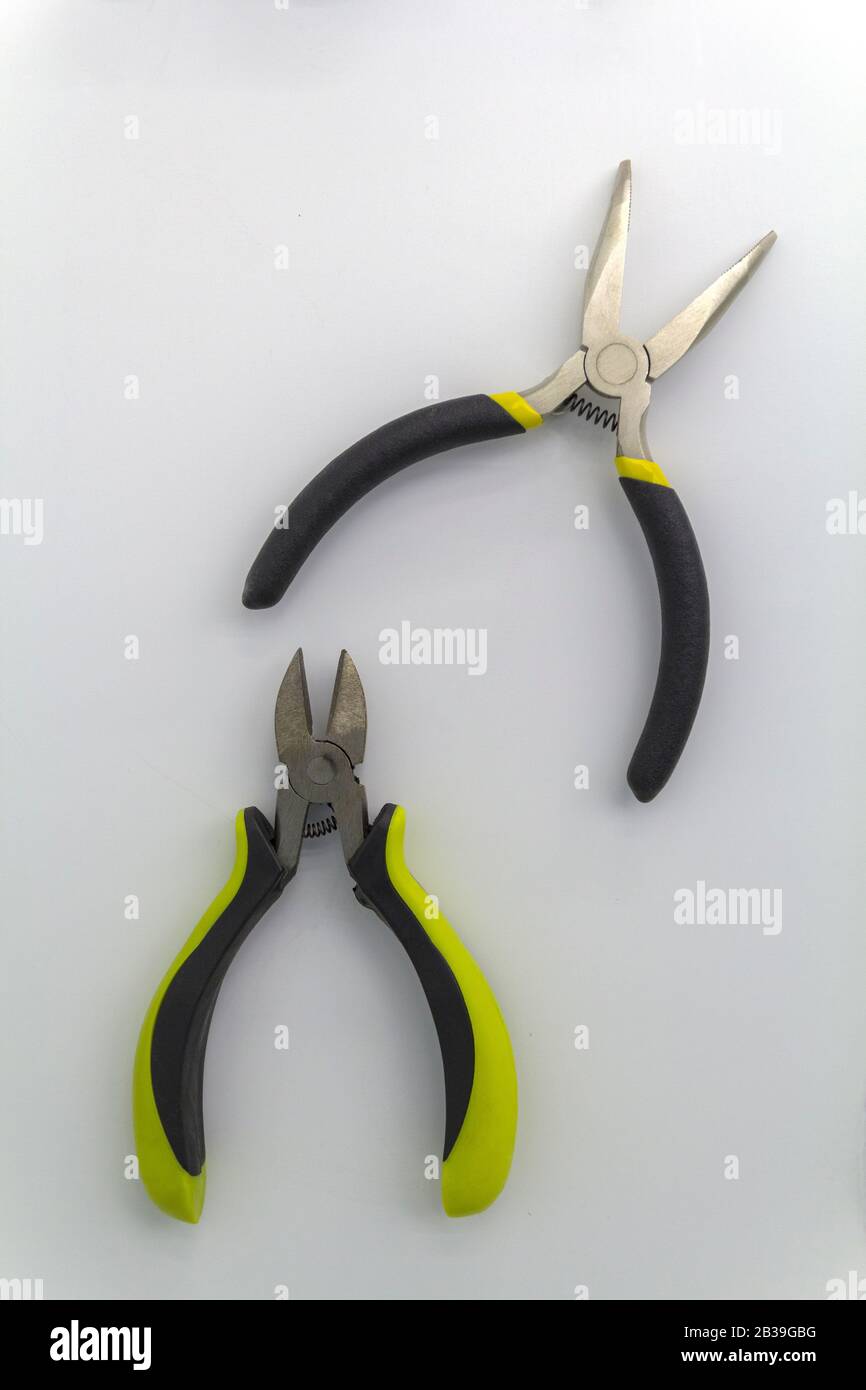 pair of old pliers with rust and dirty stain, old pliers with rust and dirty stain, isolated mechanical tool, old pliers tool with yellow grips on Stock Photo