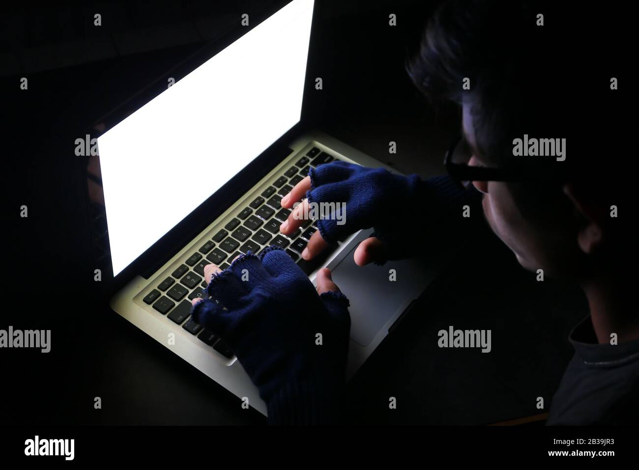 hacker stealing data laptop at night , closeup Stock Photo