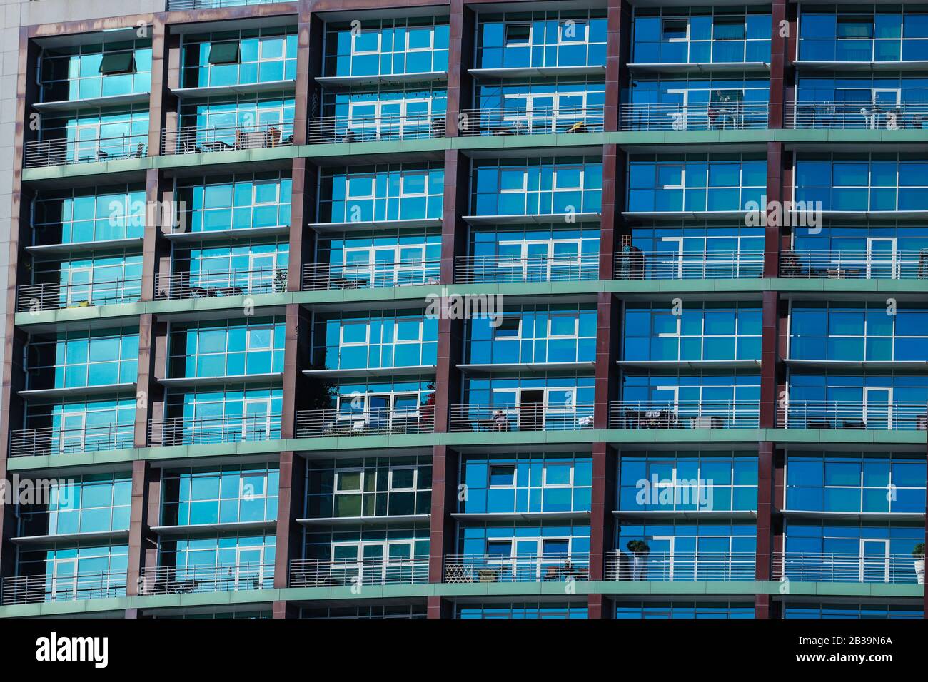Multiple windows on a large apartment building Stock Photo