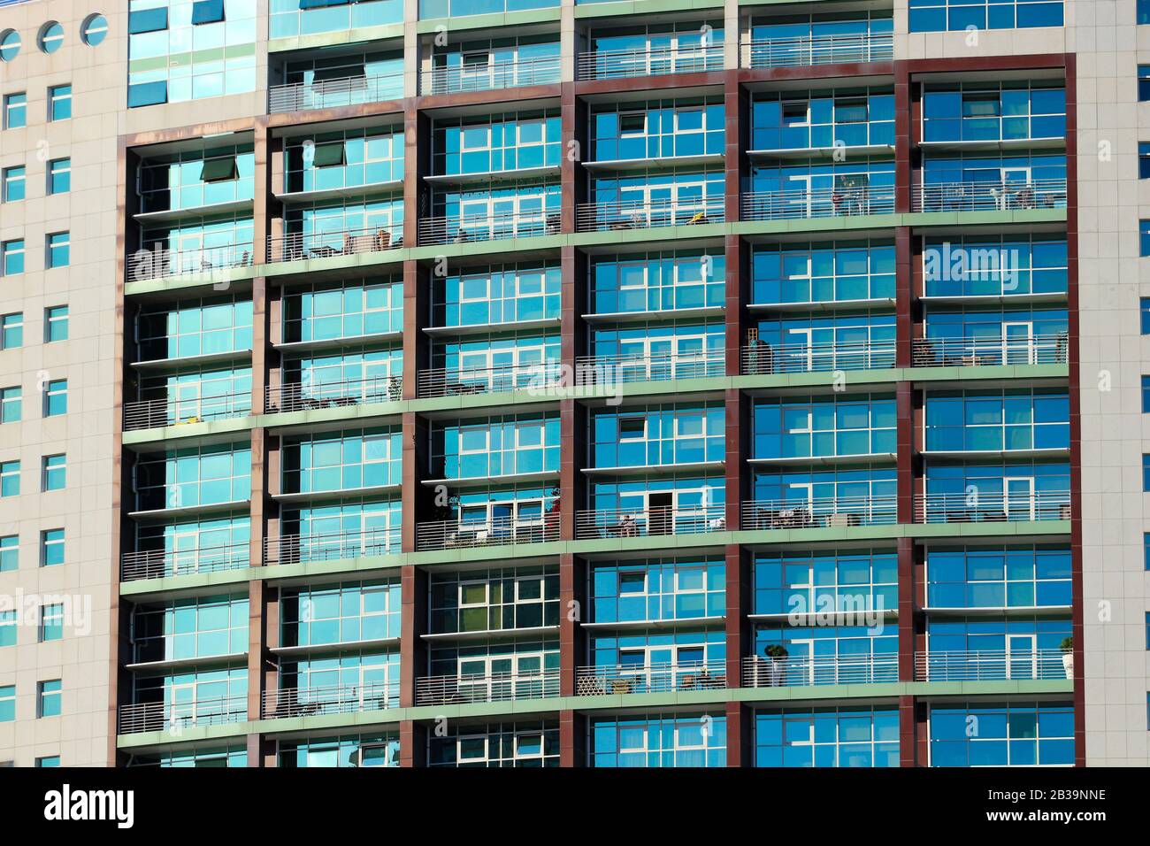 Multiple windows on a large apartment building Stock Photo