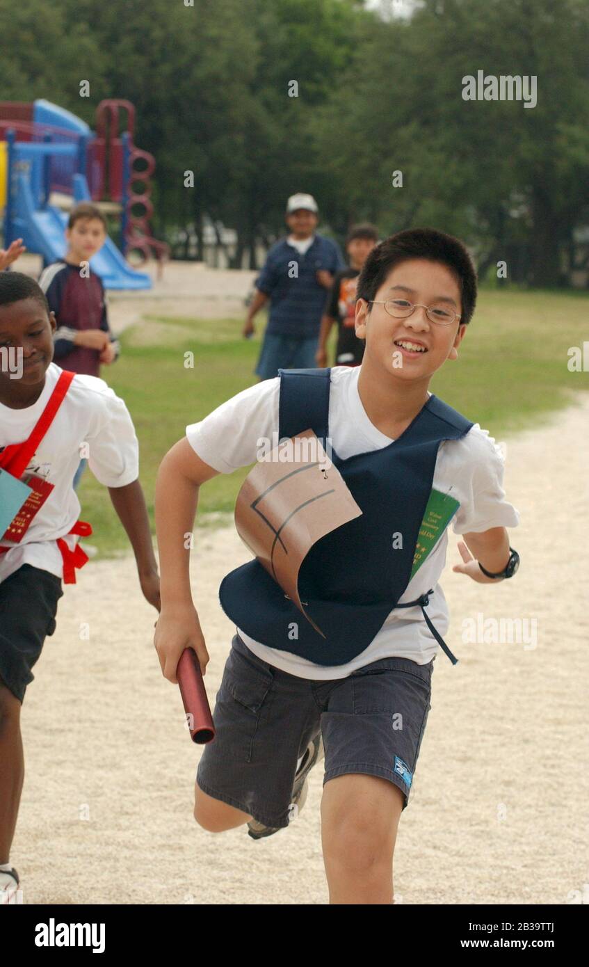 Austin Texas USA, circa 2004 Fourthgrade boys compete in relay run