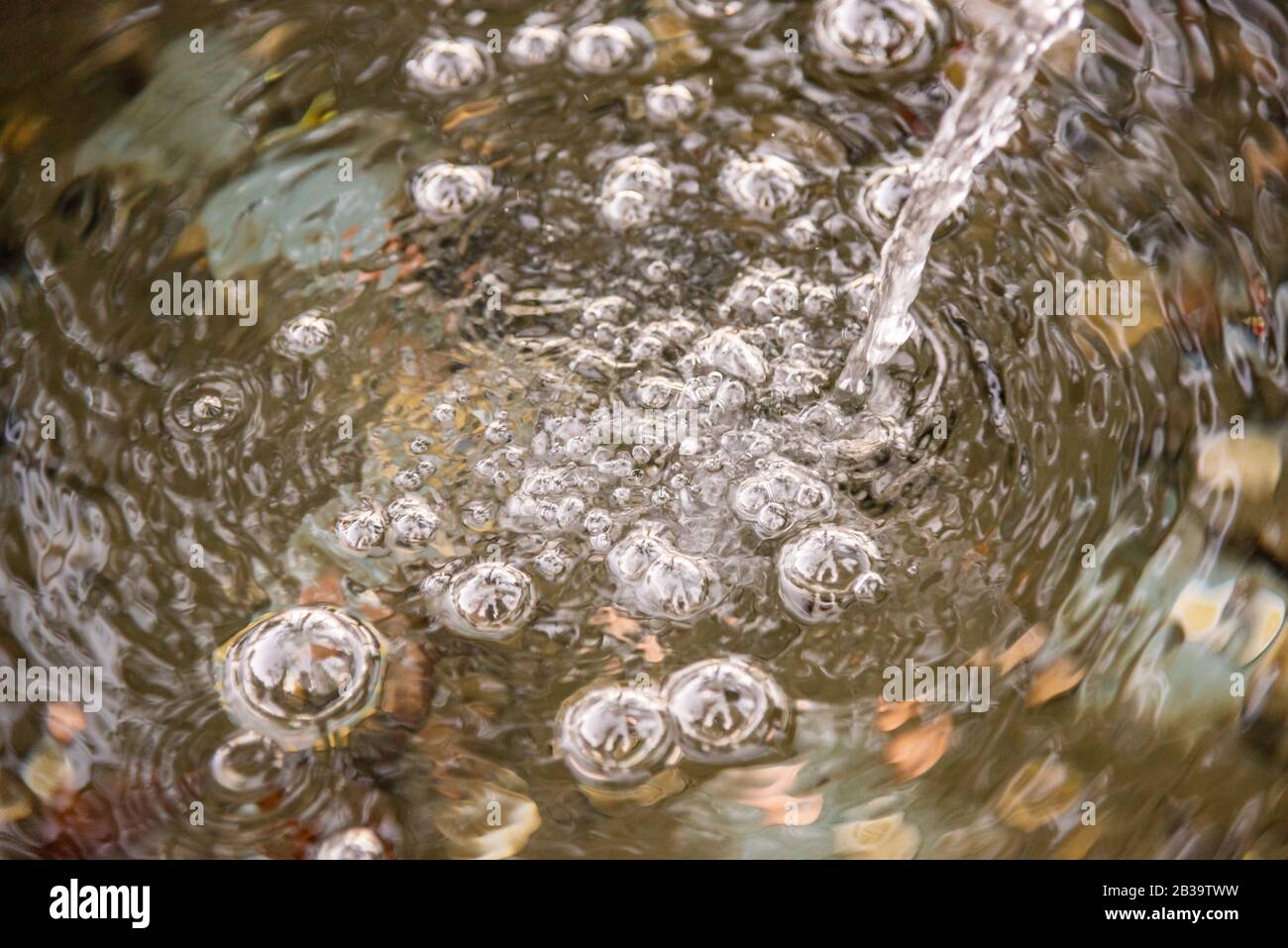 Bubbles at the surface of the water made by a trickle of water Stock Photo Alamy