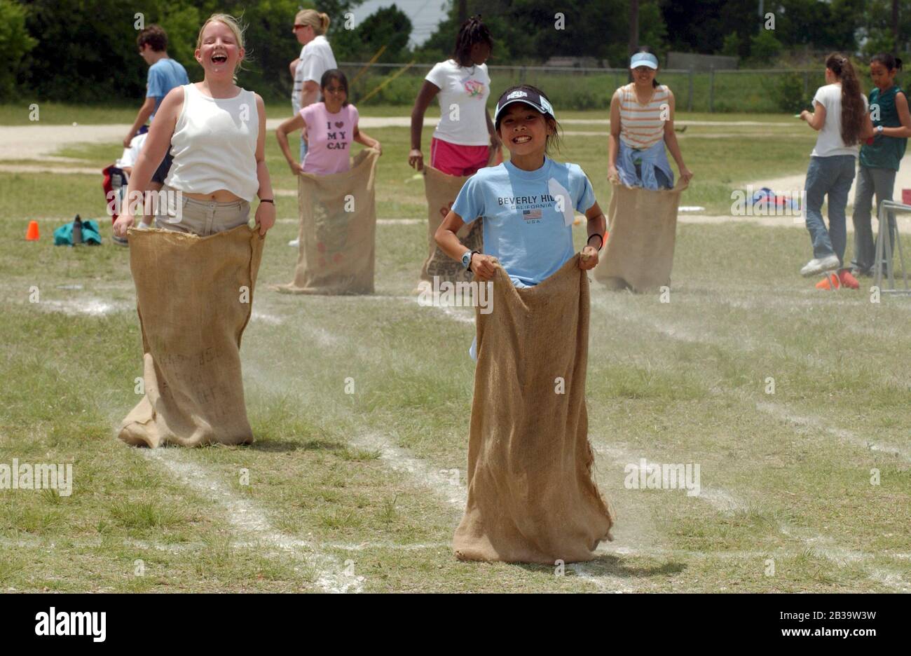 Austin Texas USA, circa 2004: Elementary school students compete in a sack race during the annual field day at Walnut Creek Elementary School. ©Bob Daemmrich Stock Photo