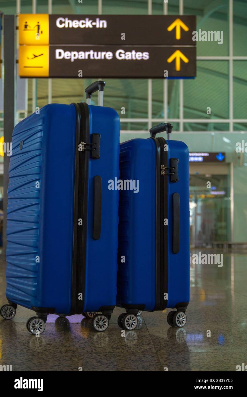 Two suitcases in the airport departure lounge, summer vacation concept