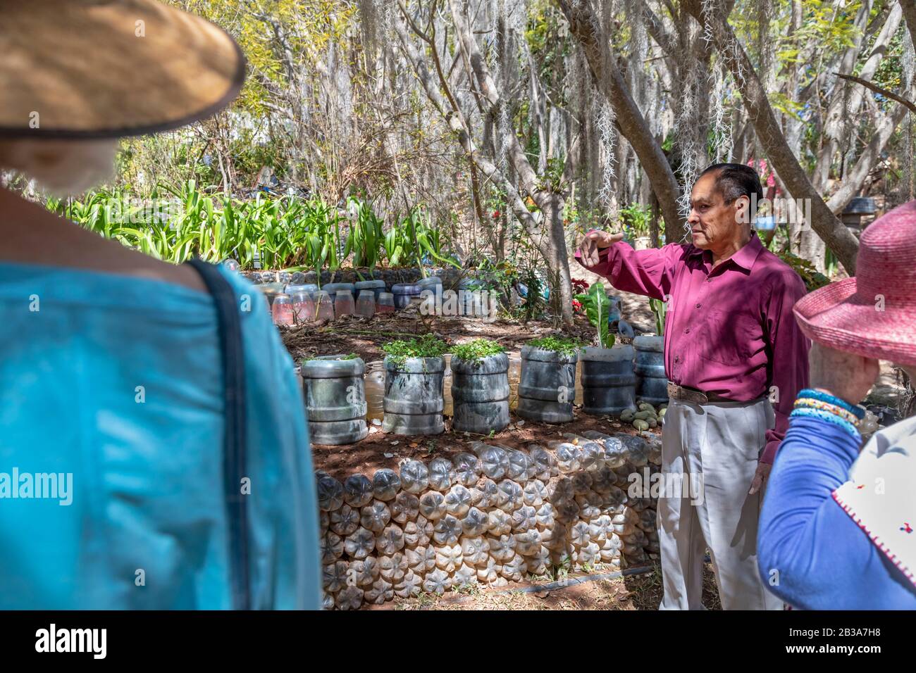 Yanhuitlan, Oaxaca, Mexico - Julio Miguel Ramírez talks with visitors about his work to restore the eroded landscape around his home. He uses various Stock Photo