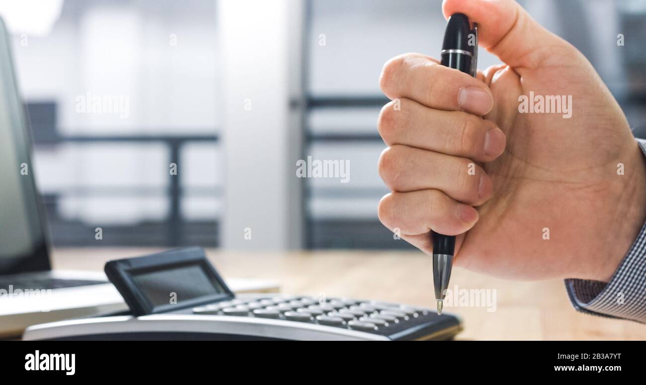 Under stress and nervous businessman clicking on pen. Anxious for Deadline at work. Stock Photo