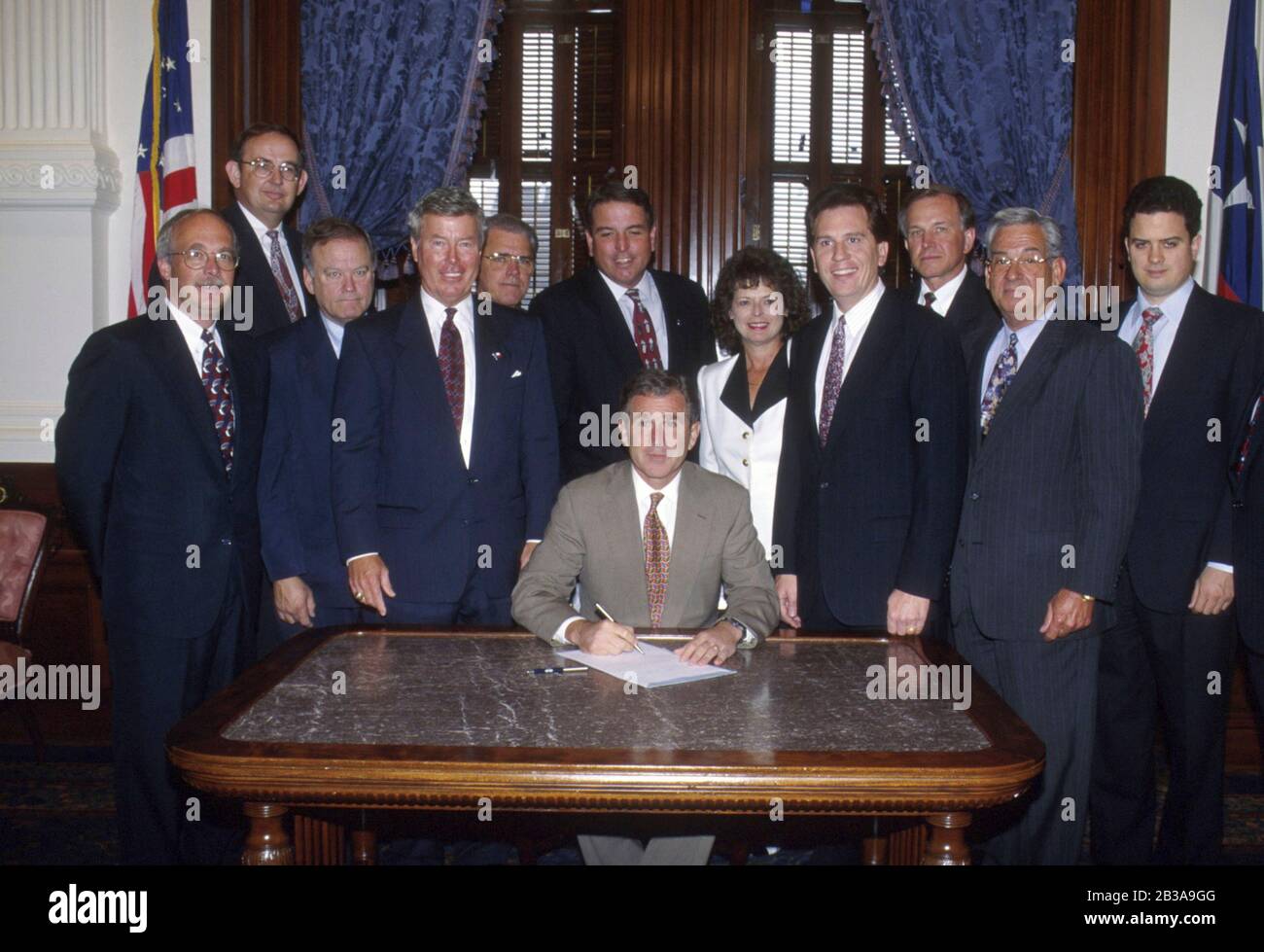Austin, Texas USA, June 29, 1995: Members of the Texas Association of Realtors surround Texas Governor George W. Bush during a bill-signing ceremony in the governor's office at the Texas Capitol. ©Bob Daemmrich Stock Photo