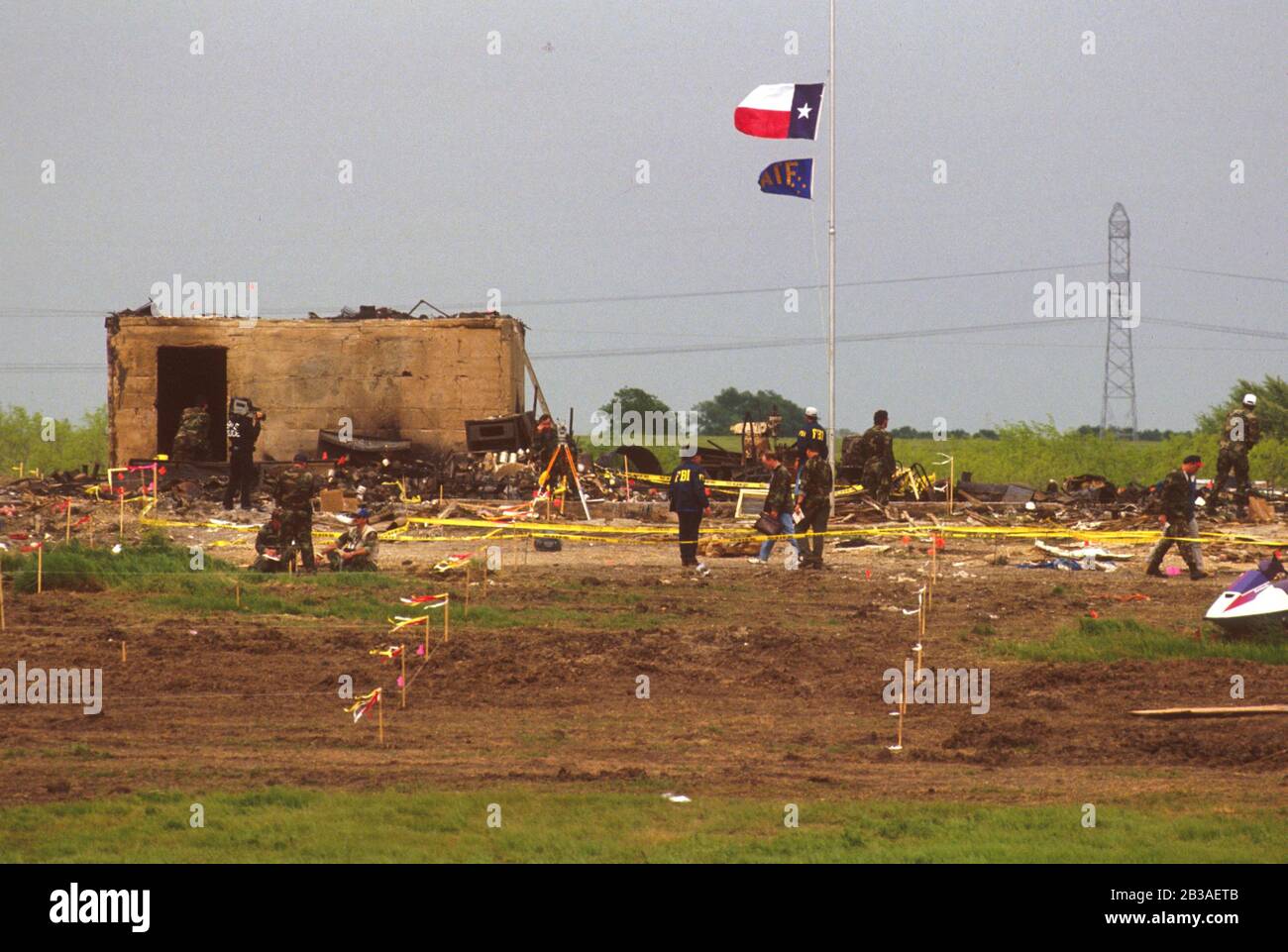 Waco Texas USA, April 1993: Federal agents scour the remains of the Branch Davidian headquarters after a fire killed 80 adults and children holed up there. The fire ended a 51-day siege of the fringe religious group's compound that began with a raid by federal Bureau of Alcohol, Tobacco and Firearms looking for illegal weapons. Four ATF agents and six Branch Davidians died in the raid, which led to the ensuing standoff that garnered international attention. ©Bob Daemmrich Stock Photo