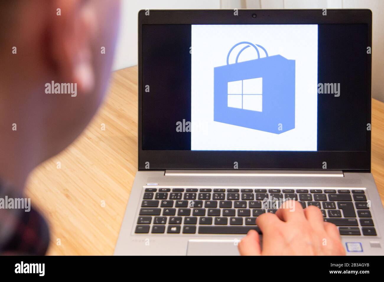 Outlook is used by a man on the laptop. Microsoft customer used computer software. New product is tested by IT specialist. San Francisco, February Stock Photo