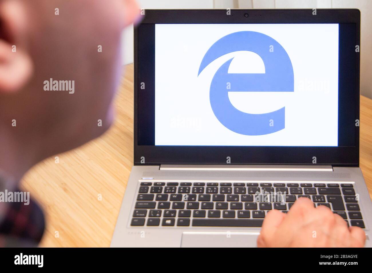 Internet explorer is used by a man on the laptop. Microsoft customer used computer software. New product is tested by IT specialist. San Francisco Stock Photo