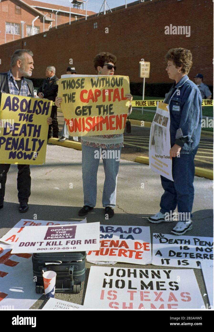 HUNTSVILLE, TEXAS USA, 03 FEB 1998:  Capital punishment opponents hold anti-death penalty placards outside Death Row at the Walls Unit of TX Dept. of Criminal Justice. They joined other pro- and anti-death penalty demonstrators hours before the scheduled execution by lethal injection of convicted murderer Karla Faye Tucker. ©Bob Daemmrich Stock Photo