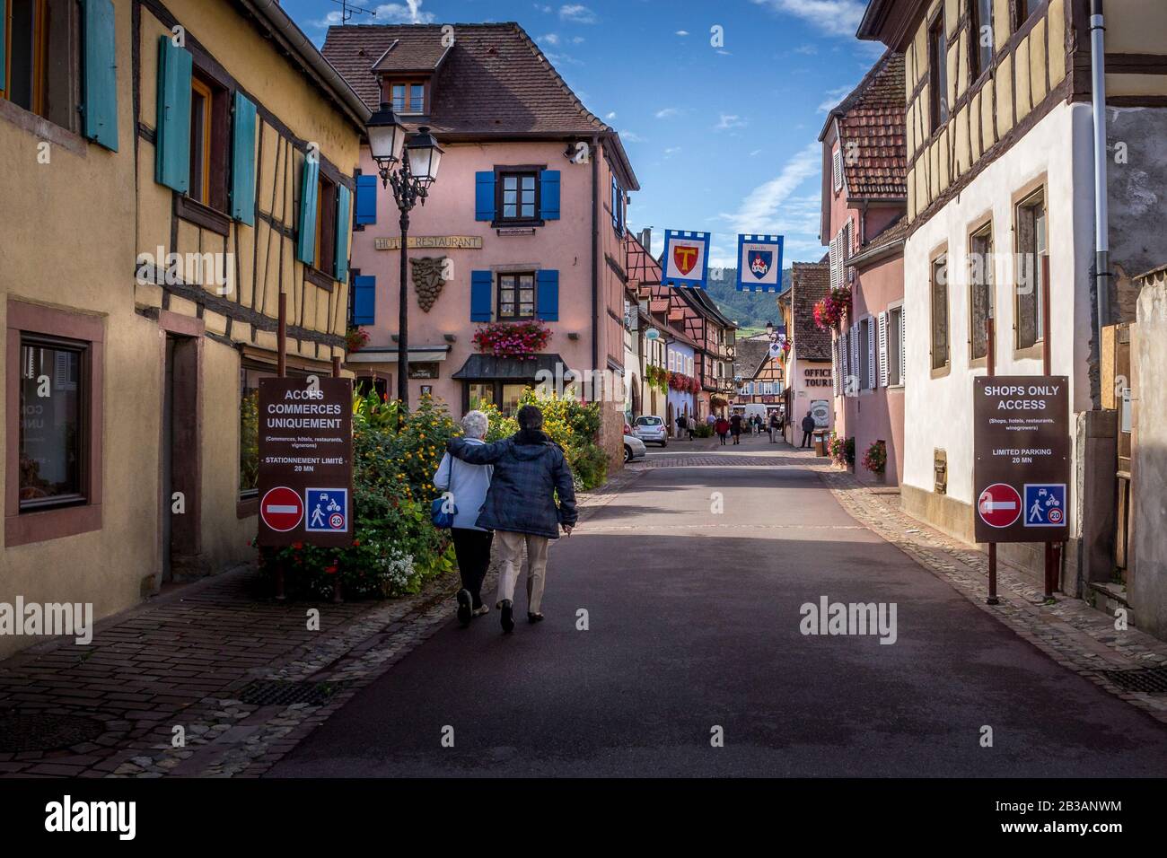Eguisheim / Alsace, France - 16 sep. 2015: Beautiful view of charming street scene with colorful houses in the historic town of Eguisheim on an idylli Stock Photo