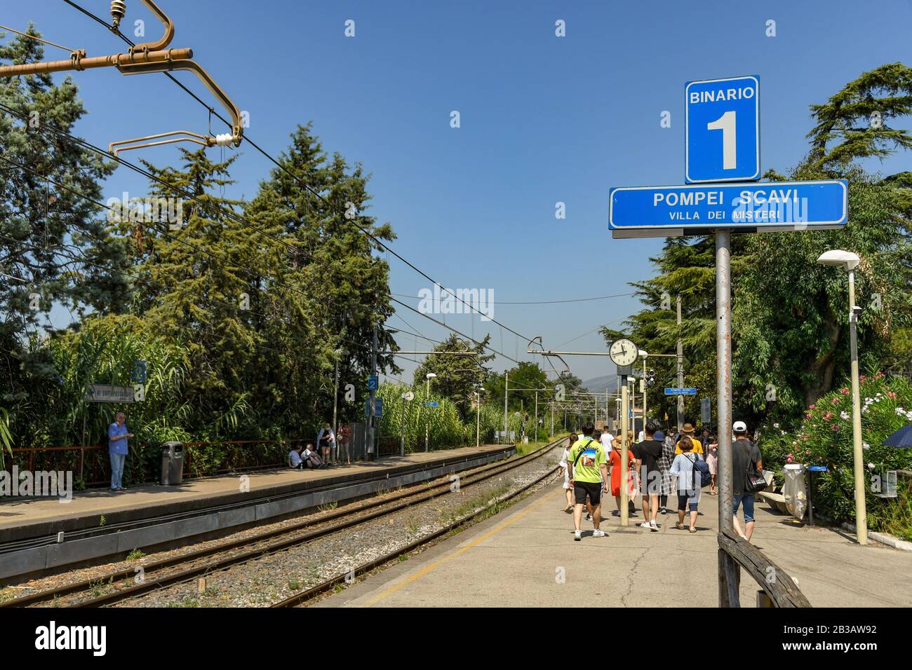 POMPEII, NEAR NAPLES, ITALY - AUGUST 2019: People on Platform 1 of Pompeii Scavi station waiting to catch a train to Sorrento Stock Photo