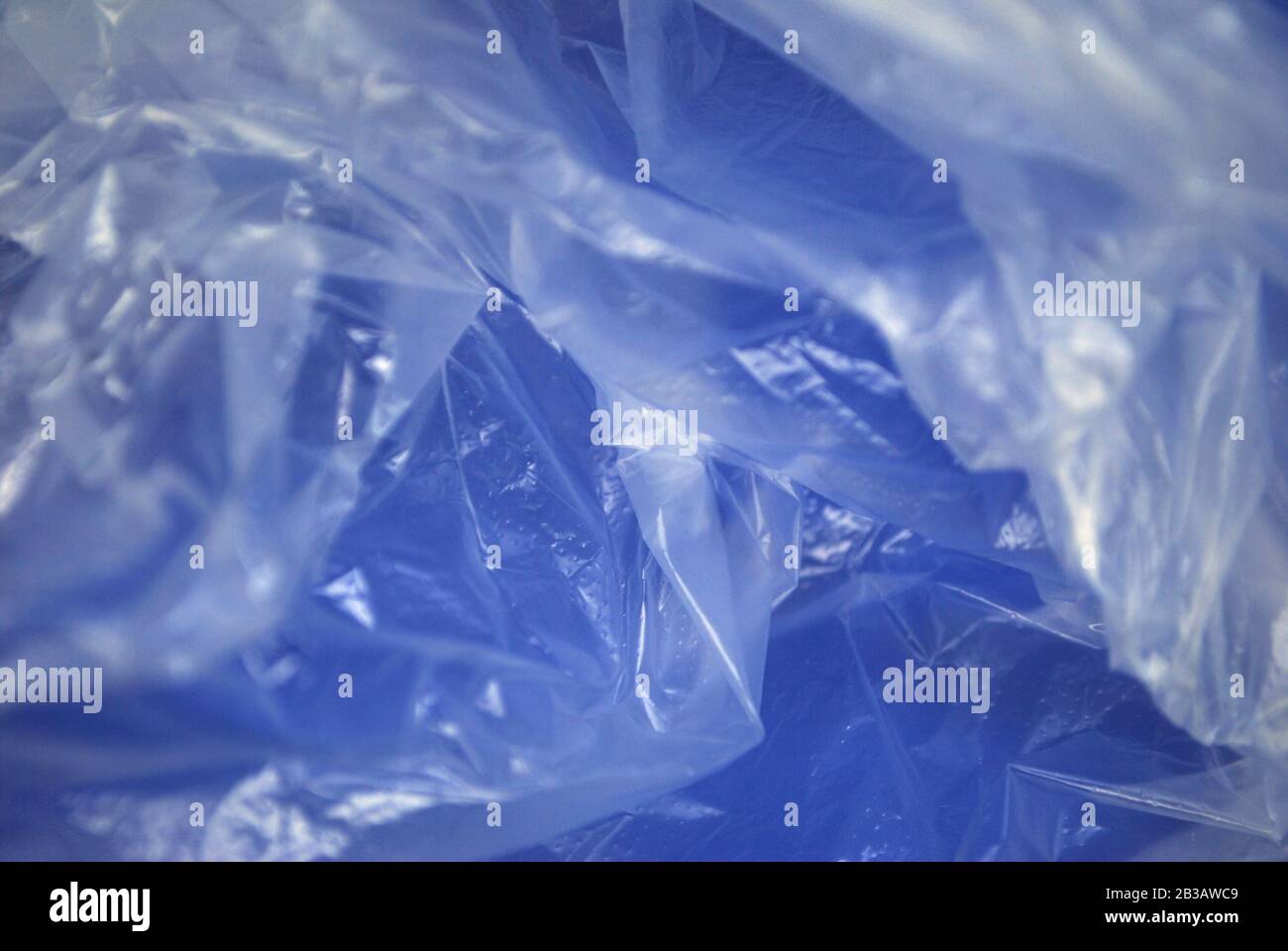 Close up view of transparent polyethylene plastic bag from on a blue background Stock Photo