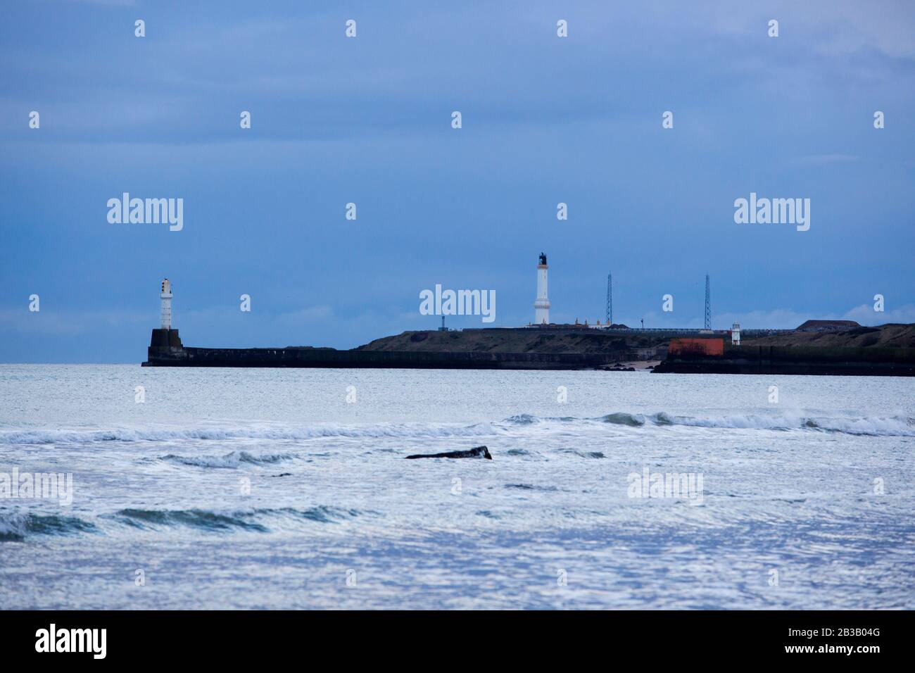 Several photos of Aberdeen South Breakwater, Girdleness Lighthouse, Greyhope Bay, and Aberdeen Harbour, big waves breaking, and vessel exiting port. Stock Photo