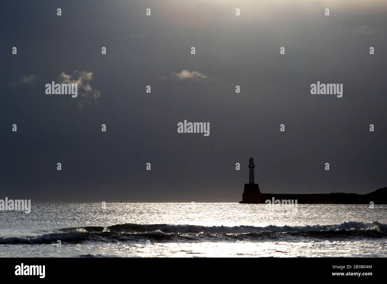 Several photos of Aberdeen South Breakwater, Girdleness Lighthouse, Greyhope Bay, and Aberdeen Harbour, big waves breaking, and vessel exiting port. Stock Photo