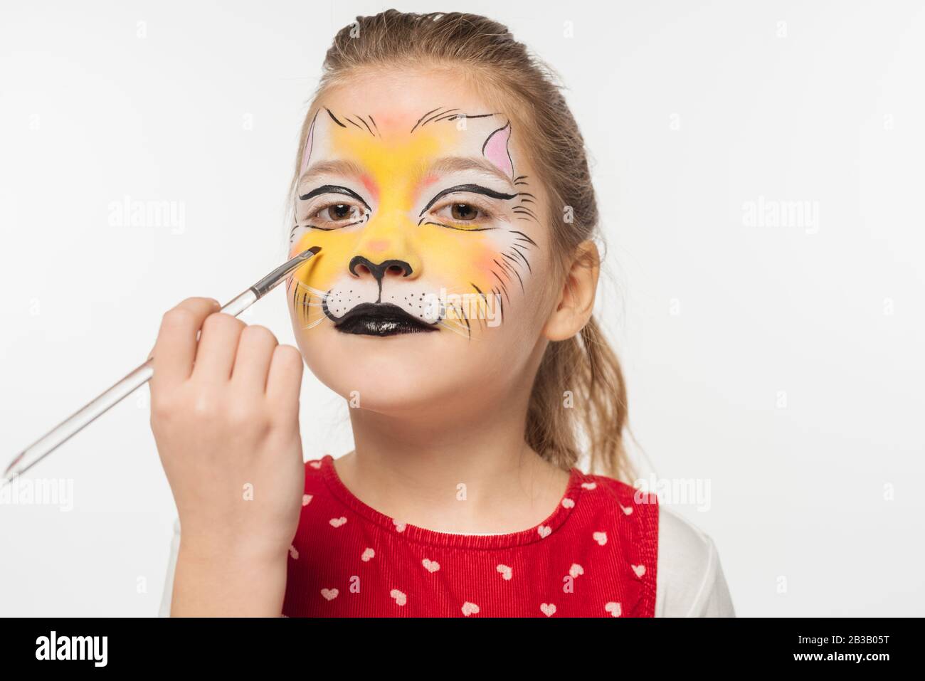 Cute Kid With Tiger Muzzle Painting On Face Holding Paintbrush