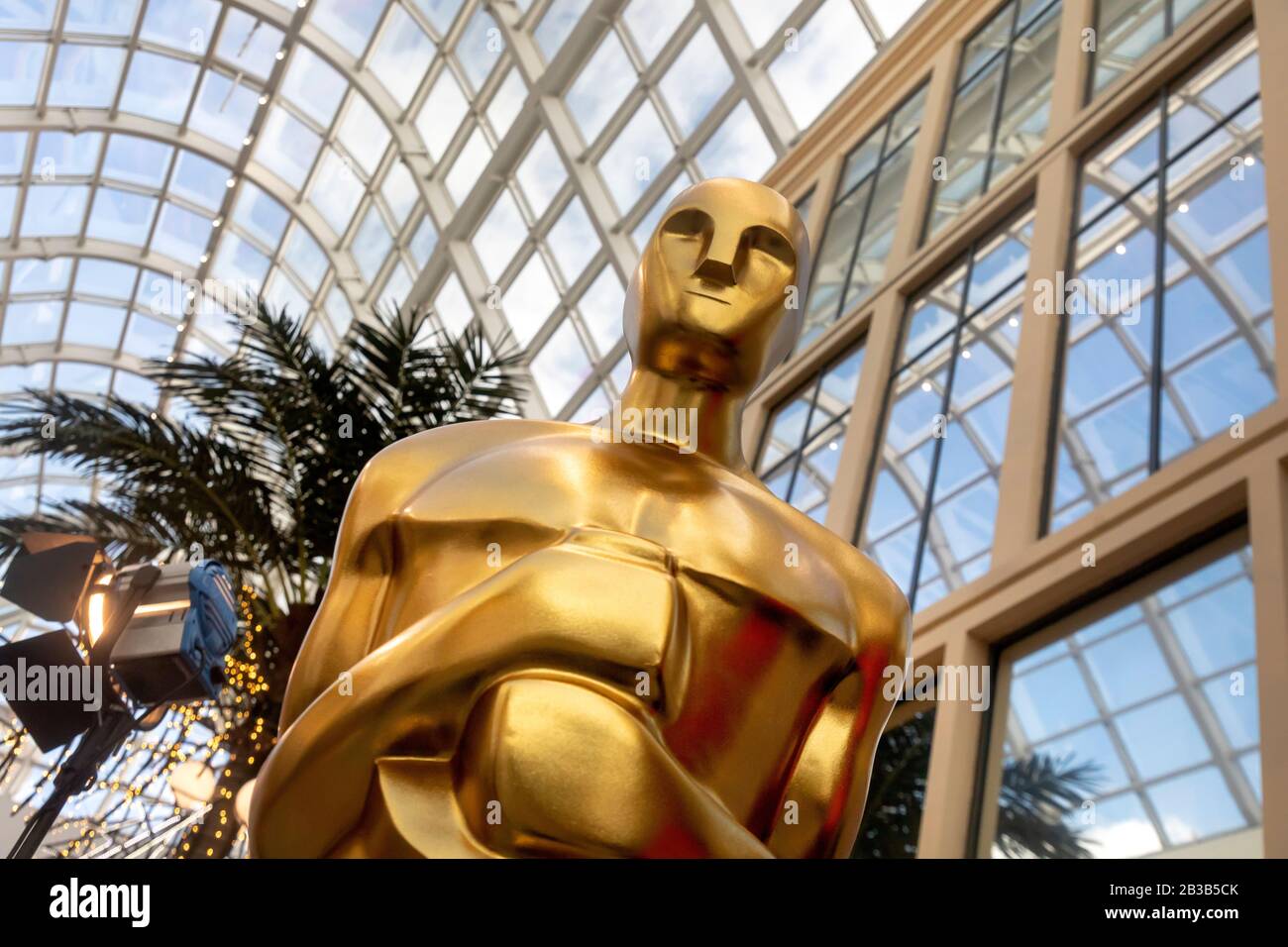 Large golden Oscar statues guard in shopping mall Stock Photo