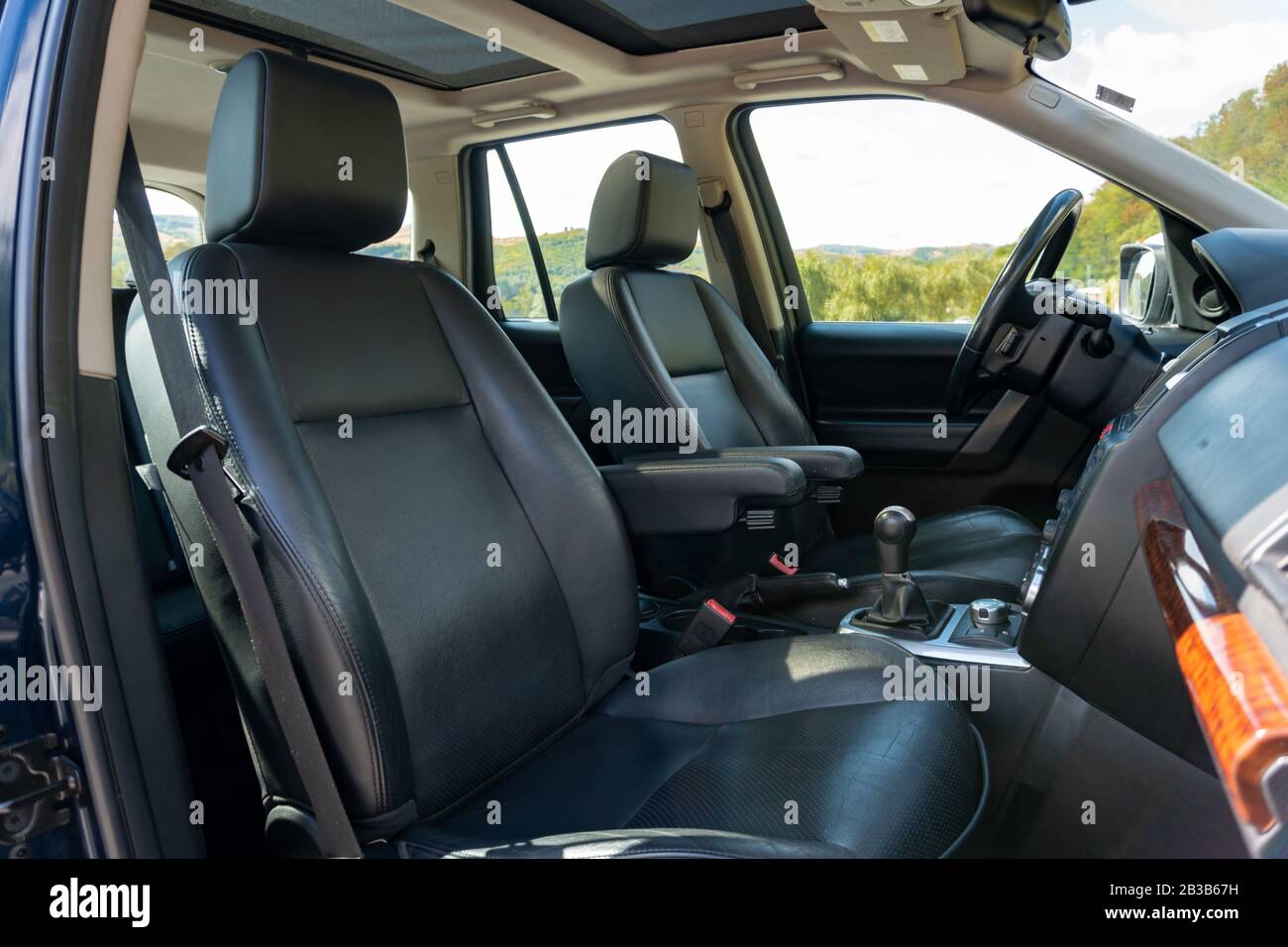 Panoramic roof - double sunroof in a luxurious suv car, glazed dach glass, blue tinted windows, and leather upholstery. Inside a luxurious SUV Stock Photo