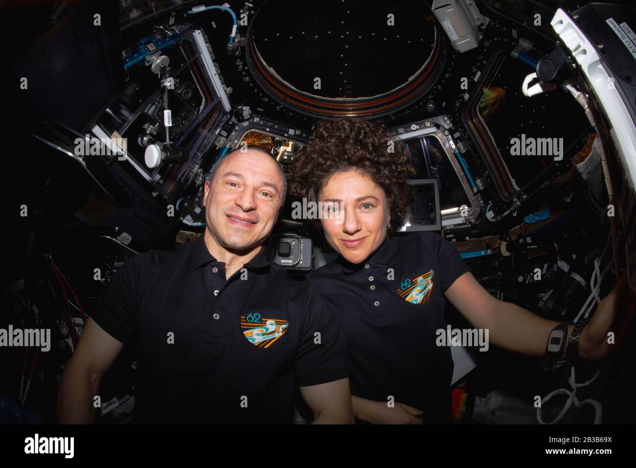 ISS - 18 Feb 2020 - NASA astronauts Andrew Morgan and Jessica Meir pose for a portrait inside the cupola, the International Space Station's 'window to Stock Photo