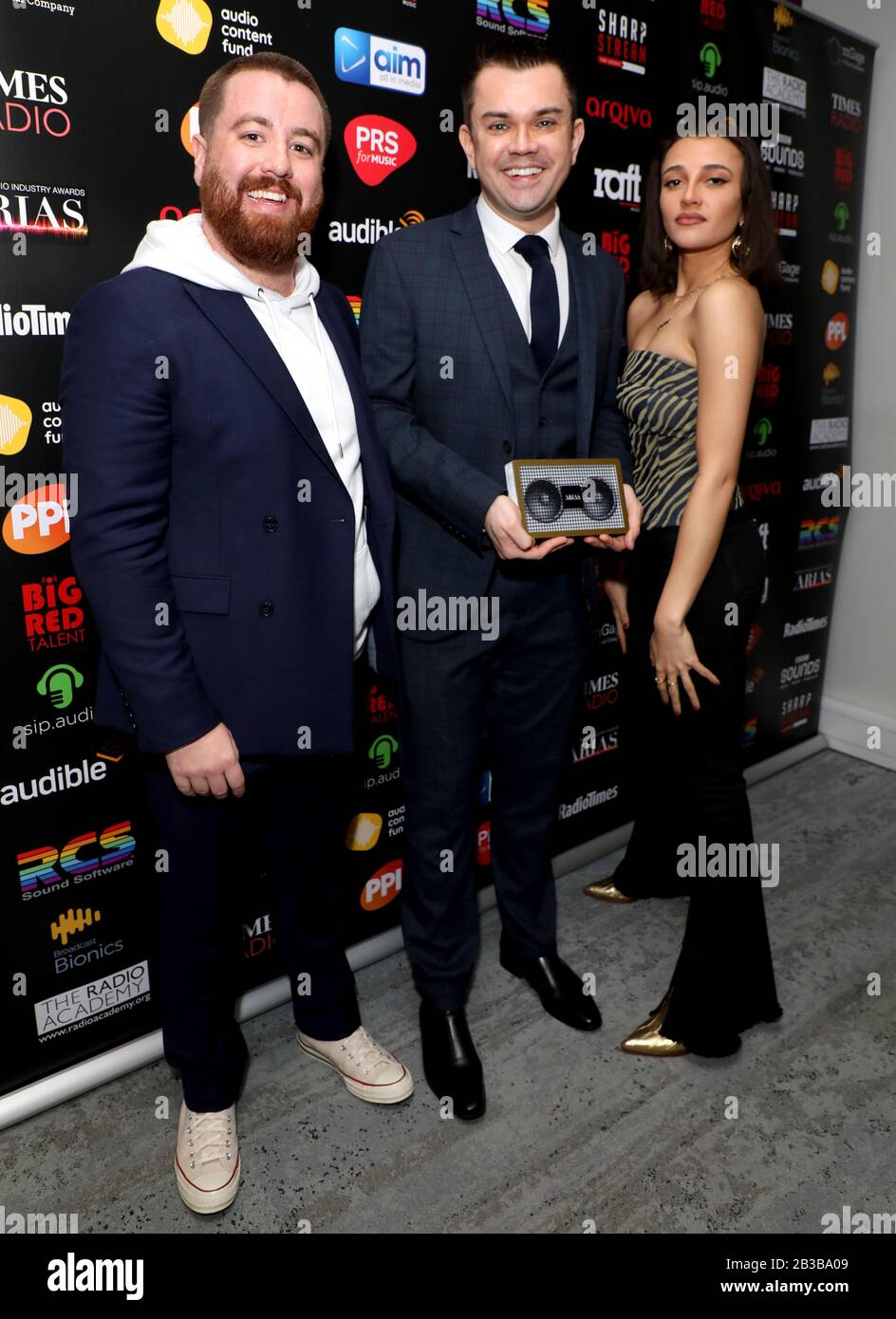 Tom Green and Daisy Maskell with Paul Sylvester (centre) with his Best Coverage of an Event award for Mental Health Awareness Week on Absolute Radio in the awards room during The Audio and Radio Industry Awards held at The London Palladium, London. Stock Photo