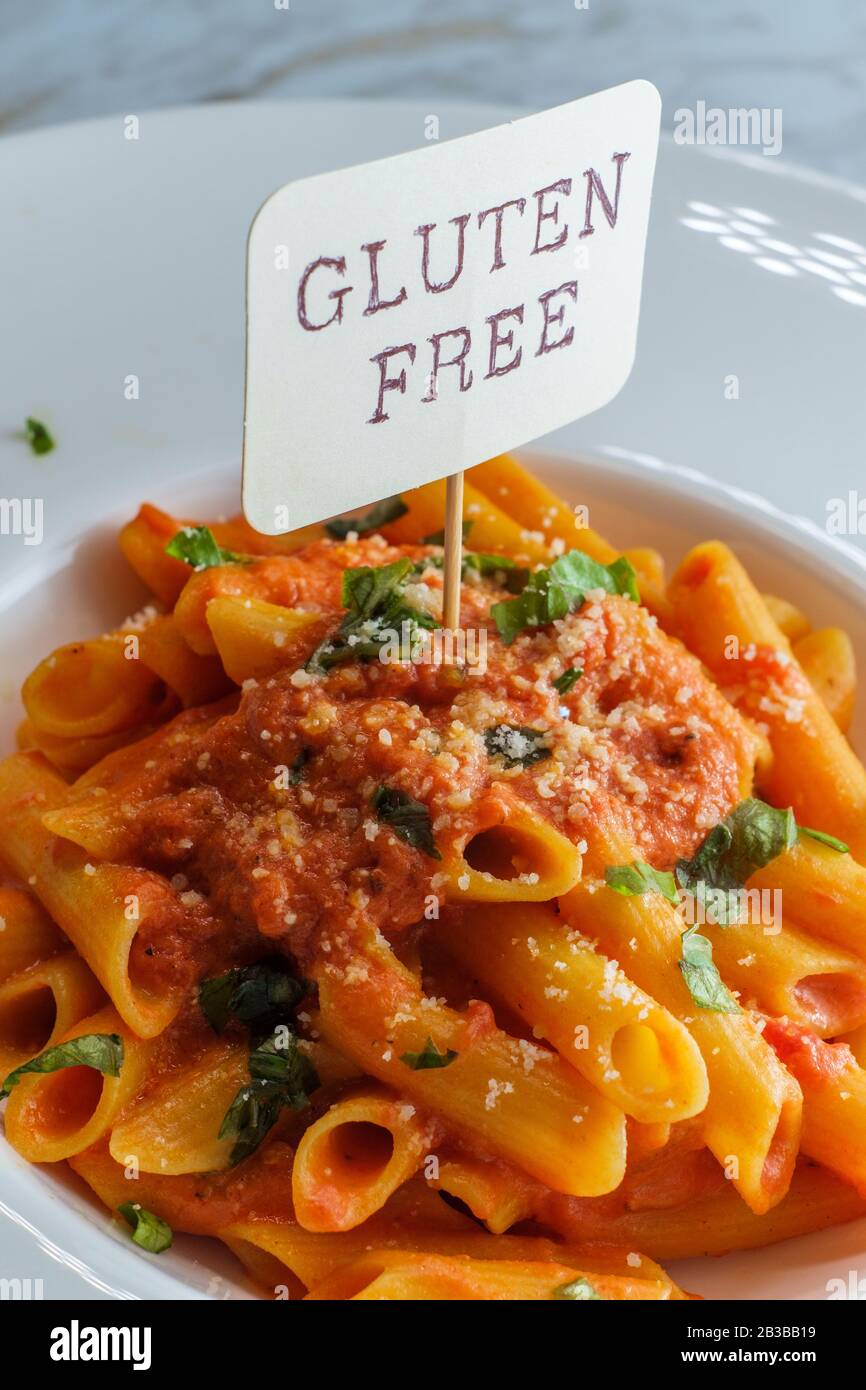 Glutenfree penne pasta in creamy vodka tomato sauce to be eaten by