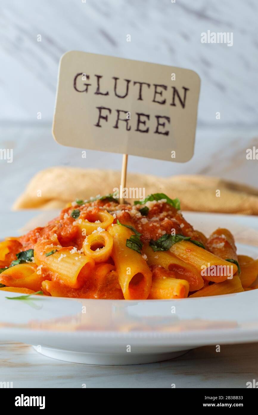 Glutenfree penne pasta in creamy vodka tomato sauce to be eaten by