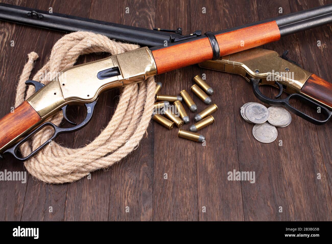 Wild west guns - lever-action repeating rifles with ammunition on