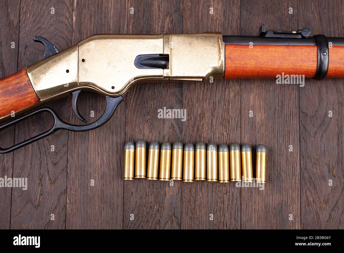 Wild west gun leveraction repeating rifle with ammunition on wooden