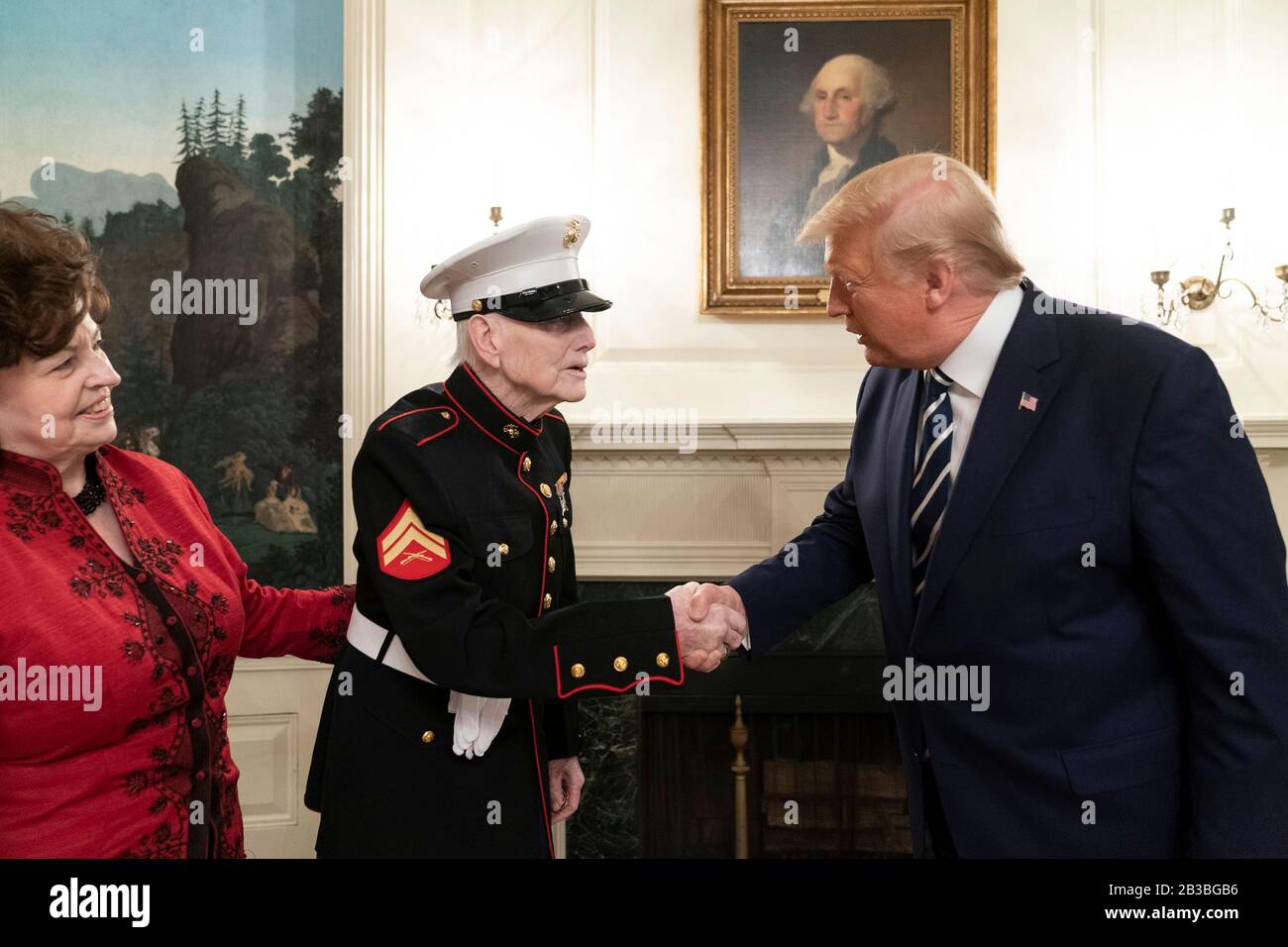 U.S President Donald Trump greets World War Two, Marine veteran of the battle of Iwo Jima, John J. Sheridan, 95, and his daughter Dianne Fairbaugh in the Diplomatic Reception Room of the White House March 3, 2020 in Washington, DC. Stock Photo