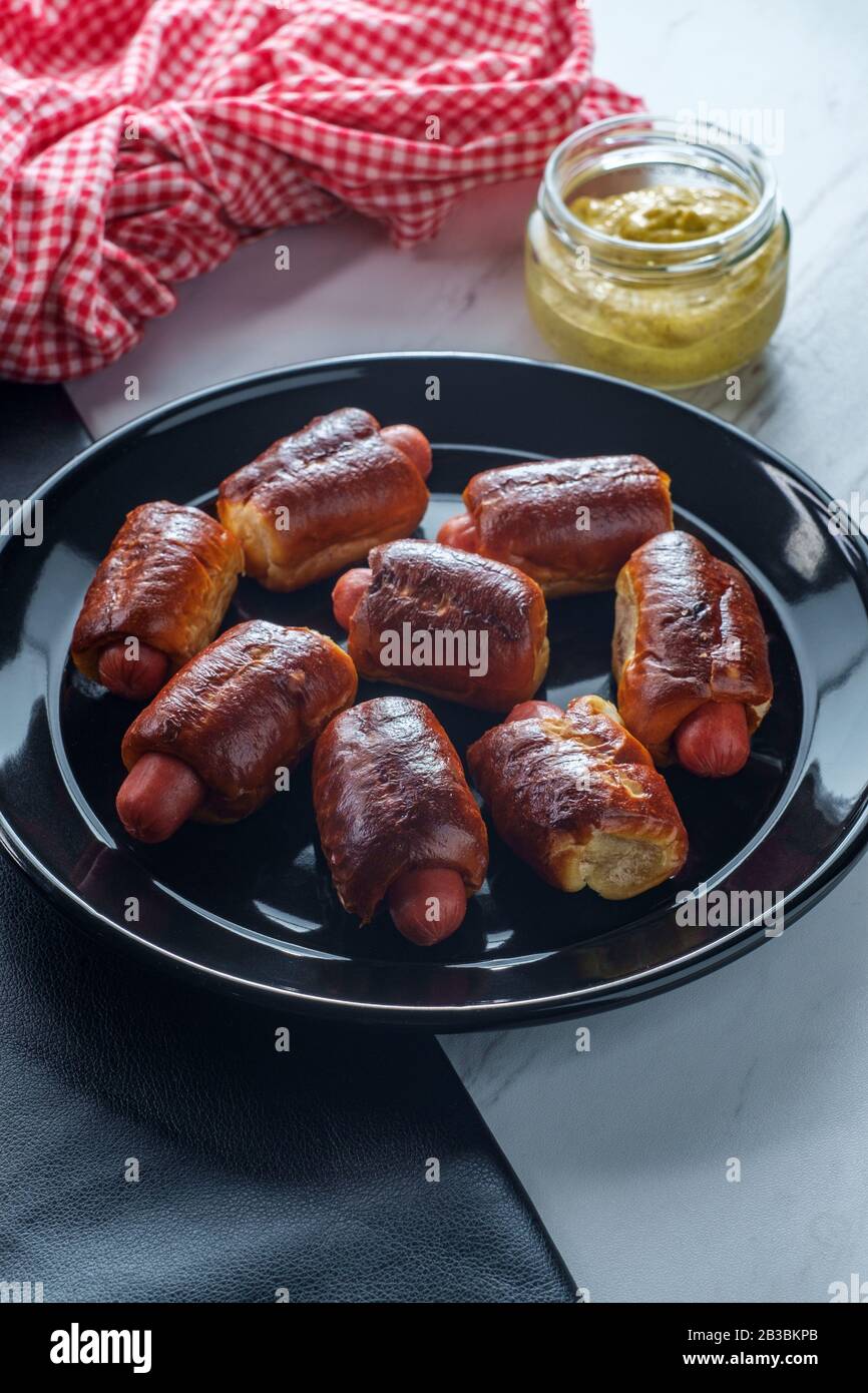 Mini pretzel hot dog pigs in a blanket with dijon mustard for dipping
