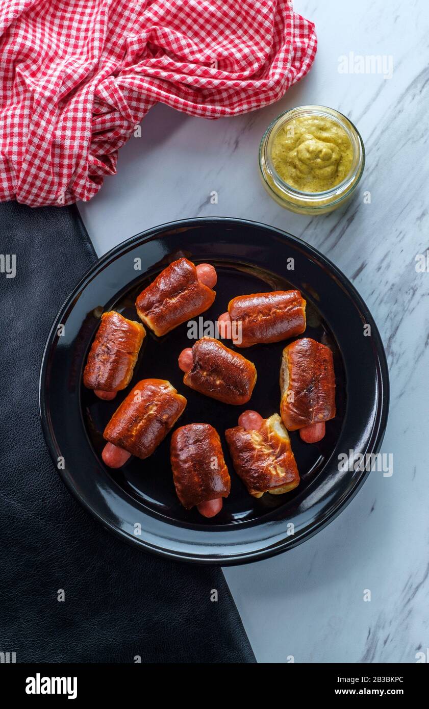 Mini pretzel hot dog pigs in a blanket with dijon mustard for dipping