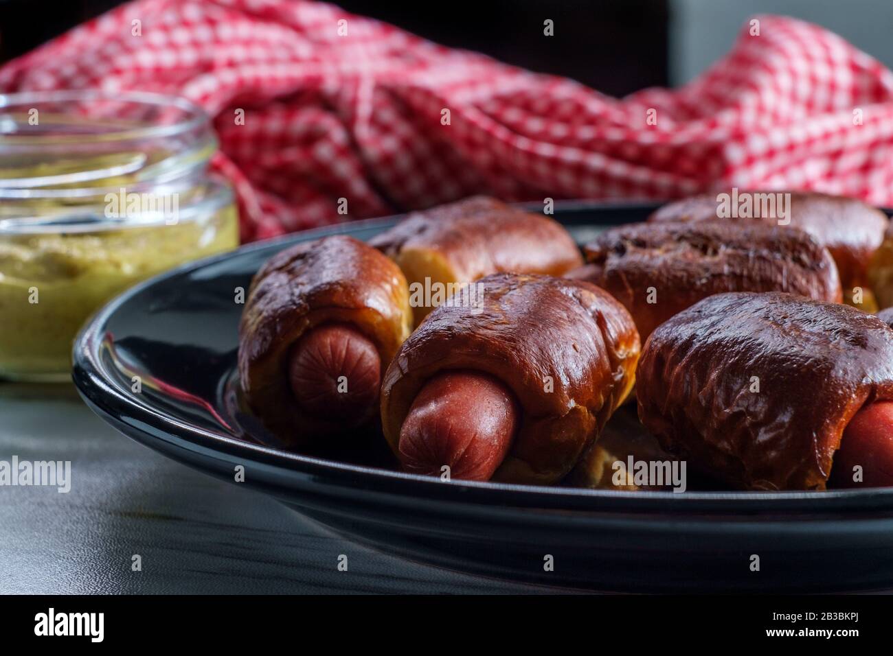 Mini pretzel hot dog pigs in a blanket with dijon mustard for dipping