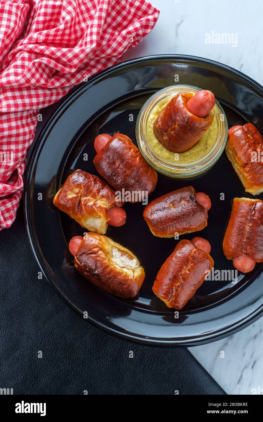 Mini pretzel hot dog pigs in a blanket with dijon mustard for dipping