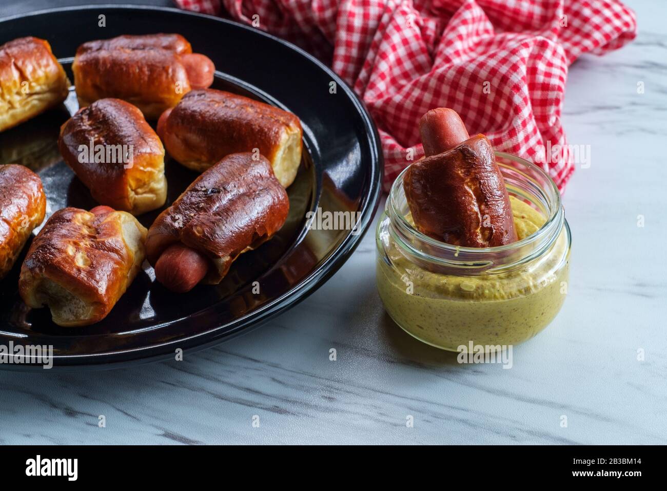Mini pretzel hot dog pigs in a blanket with dijon mustard for dipping