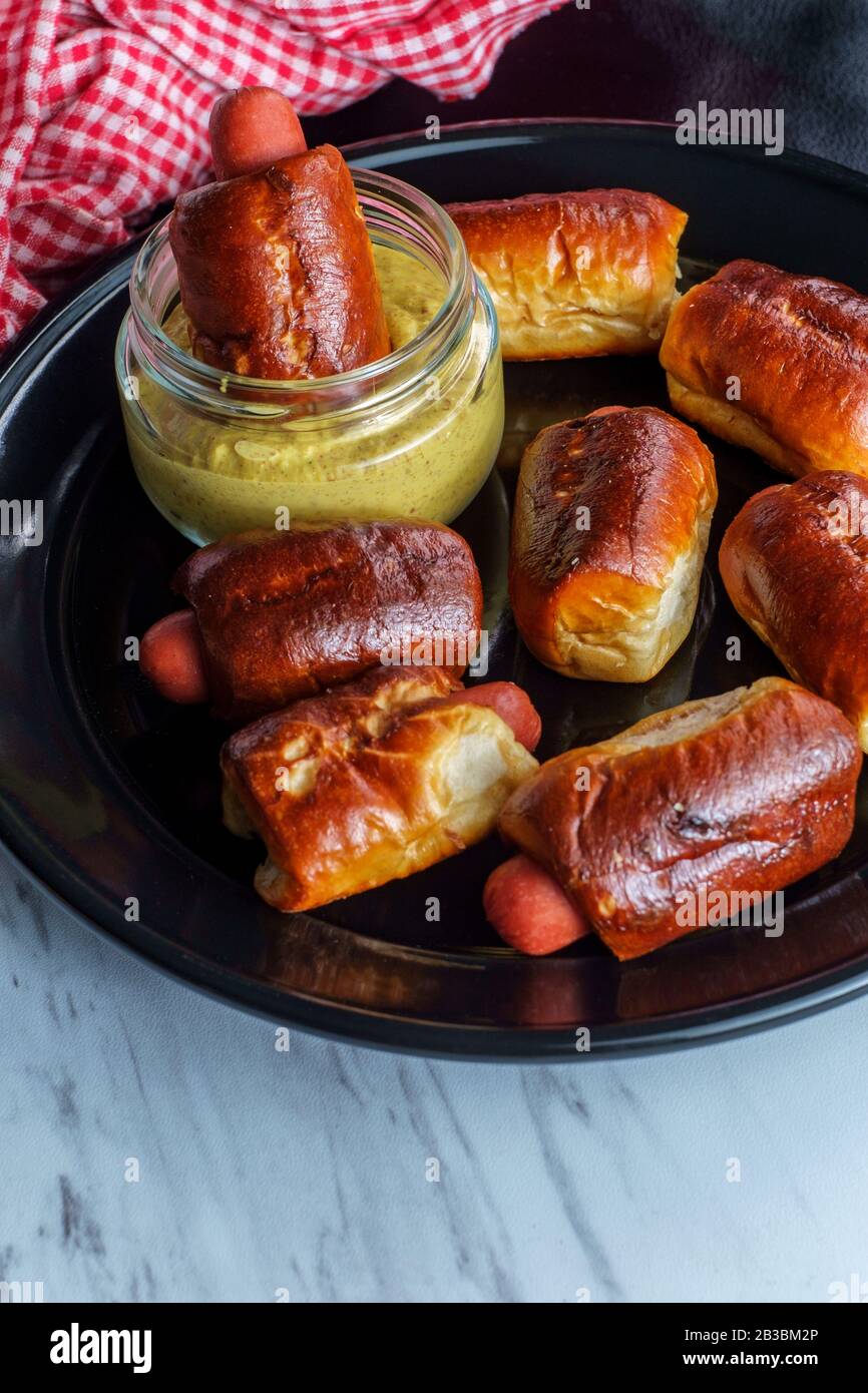 Mini pretzel hot dog pigs in a blanket with dijon mustard for dipping