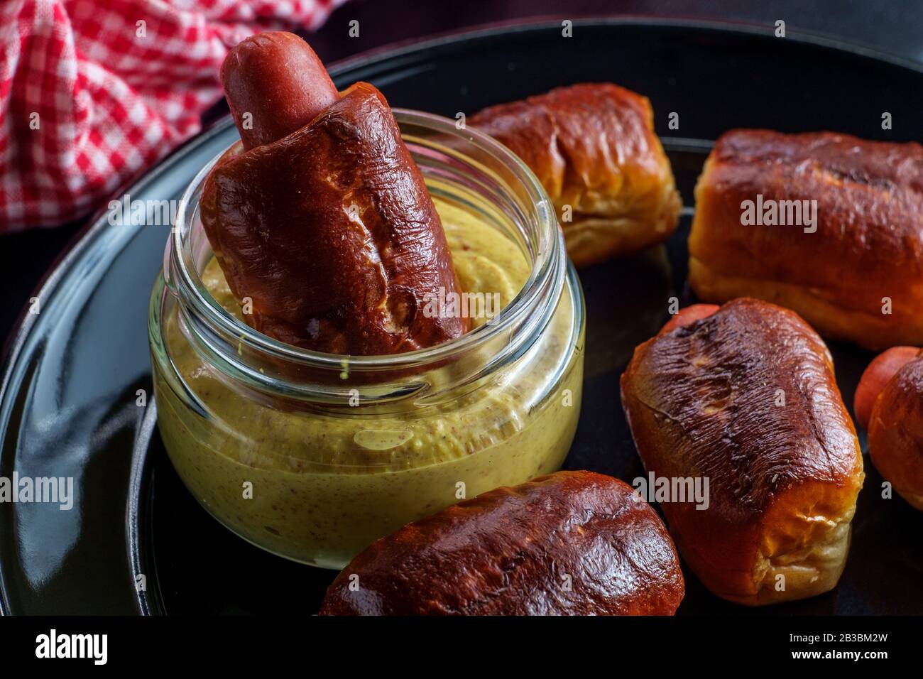 Mini pretzel hot dog pigs in a blanket with dijon mustard for dipping