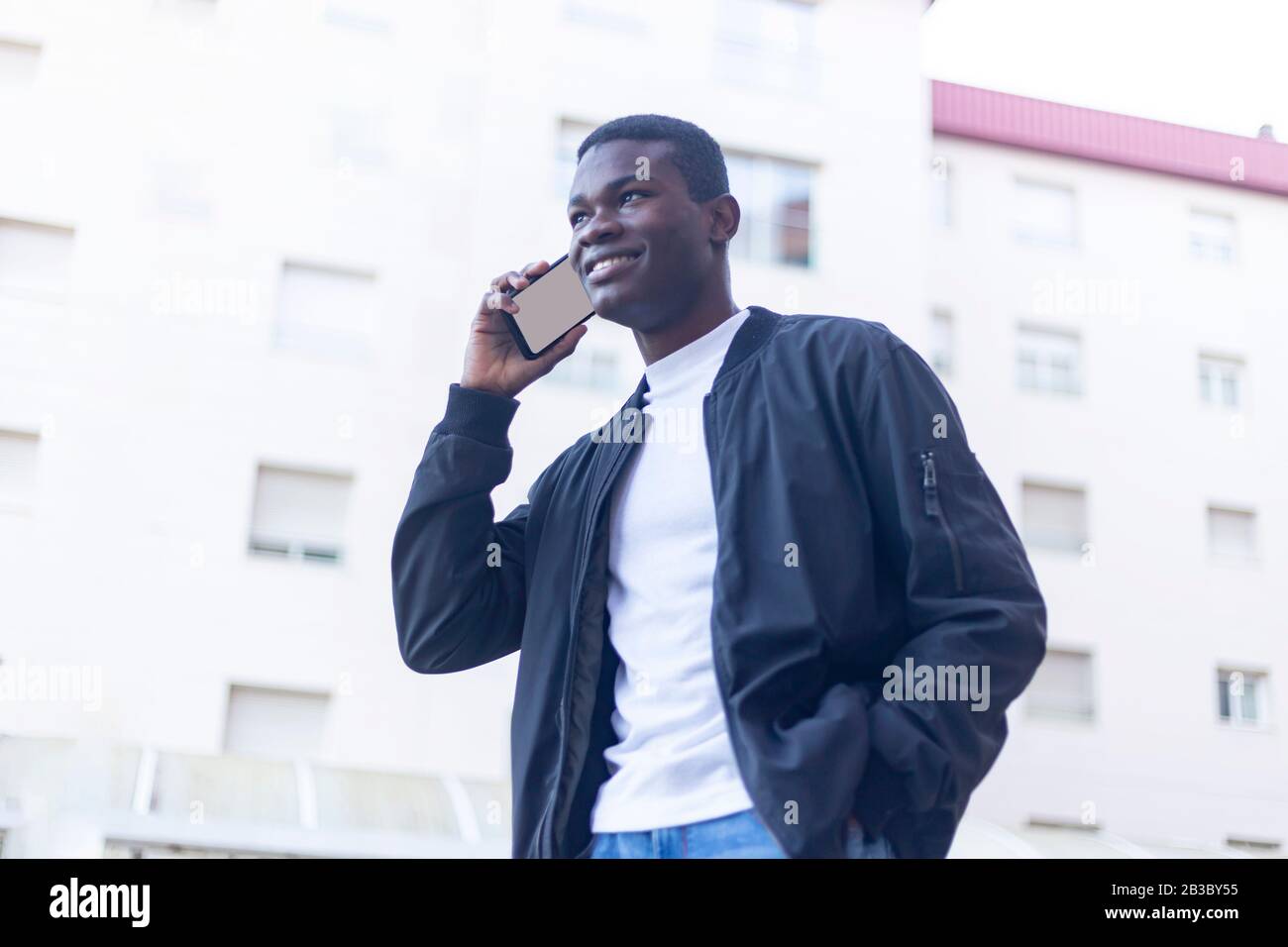 Afro man using mobile phone. Stock Photo