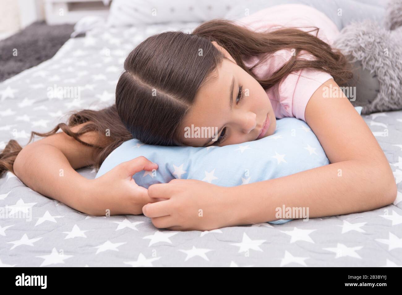 Sleepy beauty. Sleepy baby. Small girl relax in bed. Little child with sleepy look. Early morning or late evening. Bedtime routine. Nap time. She feels sleepy. Stock Photo